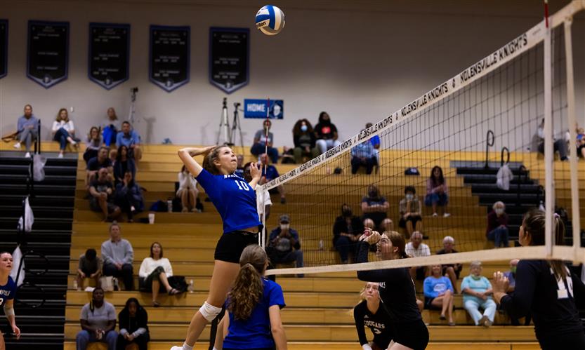 High school students play volleyball